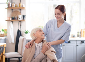 Aged pensioner feeling thankful to her pleasant caregiver